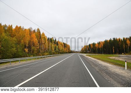 Karelia, Russia. The Highway Kola Through The Autumn Forest. Kola Road.