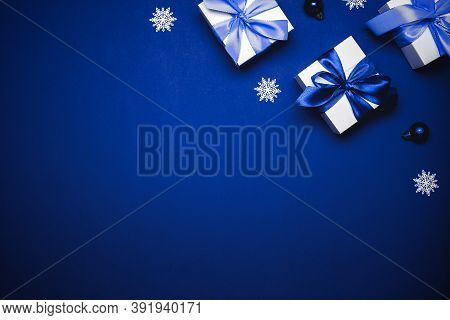 Winter Background Blue. White Gift With Cyan Bow, Blue Balls And Winter Tree In Xmas Decoration On A