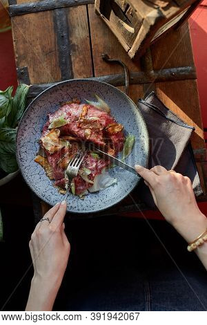 A Female Hand Is Preparing A Vegetable Salad With Beef Roast Beef. A Plate Of Salad With Beef Roast 