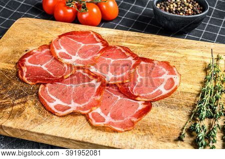 Raw Smoked Meat Jamon Lomo. Black Background. Top View
