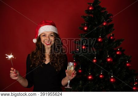 Cheerful Charming Woman In Santa Hat Celebrating New Year, Christmas, Hanukkah, Kwanzaa Holiday. Smi