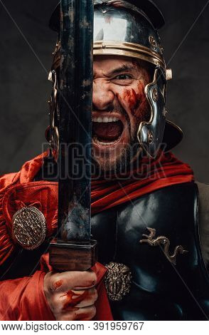 Armoured And Savage Greece Warrior With Red Mantle And Helmet Screams Holding His Gladius In Dark Ba