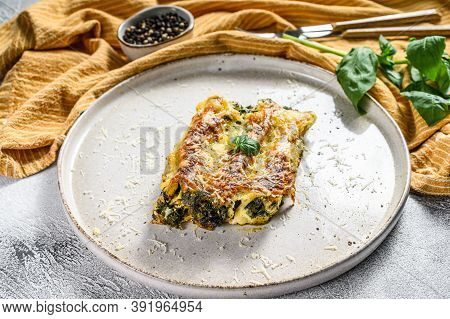 Baked Stuffed Vegetarian Pasta Cannelloni With Broccoli, Spinach, Basil And Cheese. Gray Background.
