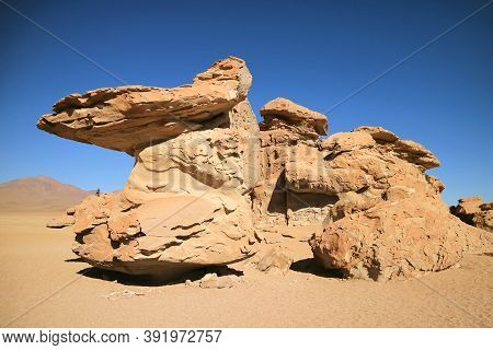 Amazing Rock Formation At Eduardo Avaroa Andean Fauna National Reserve With A Visitor Photographing,