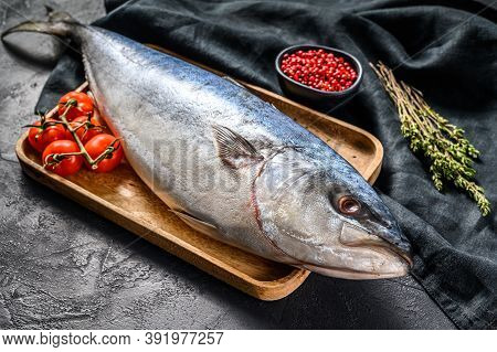 Fresh Whole Japanese Amberjack. Raw Fish Yellowtail. Black Background. Top View