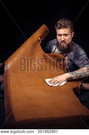 Leather Worker Cutting Out Leather Shapes For A New Product