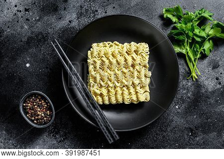 Dry, Raw Quick Cooking Noodle, Instant Noodles. Black Background. Top View