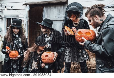 Scary Family,mother,father,daughters Celebrating Halloween.pumpkins Jack-o-lantern.terrifying Black 