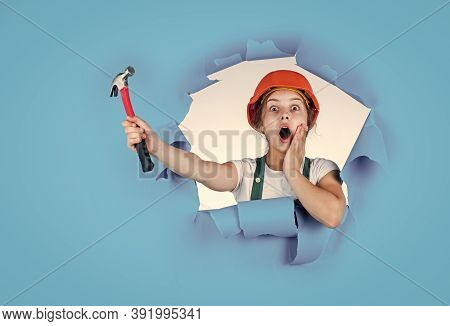 Feel The Surprise. Labor Day At 1 May. Surprised Girl In Hard Hat Holds Hammer. Best Repairer Ever. 