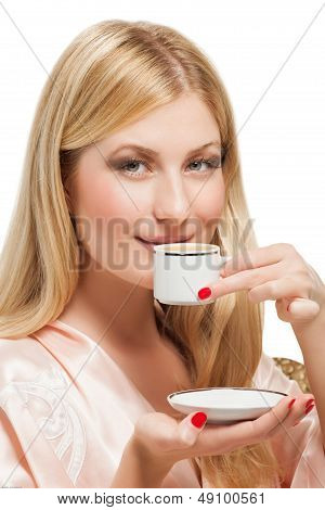 Beauriful girl in nightgown drinking coffee