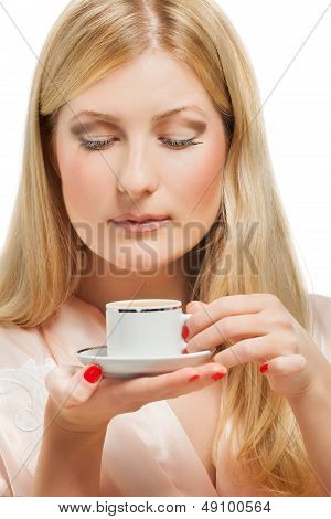 Beauriful girl in nightgown drinking coffee