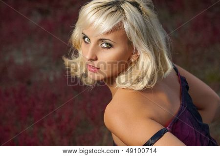 Young Blond Woman In A Purple Dress