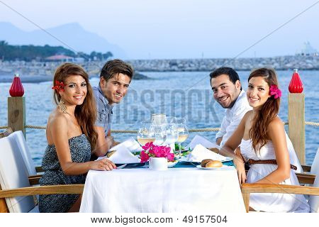 Two Happy Couples Having Dinner At The Seaside