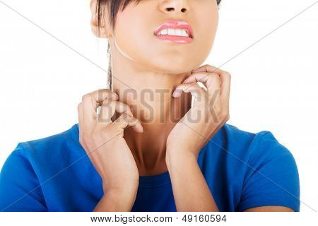 Young beautiful woman scratching her self. Isolated on white 