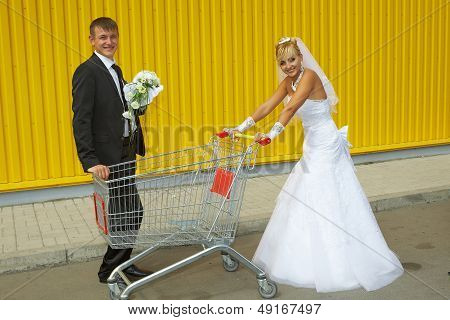 Bride And Groom Playing With A Basket Of Supermarket