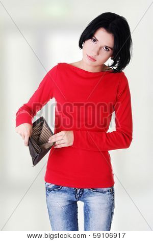 Young woman shows her empty wallet. Bankruptcy concept