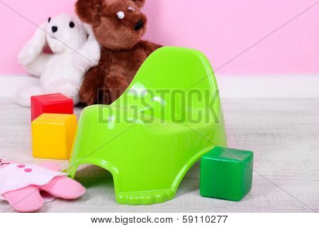 Green potty on home interior background
