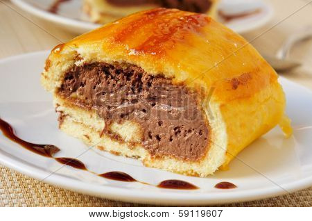 a piece of brazo de gitano, typical spanish swiss roll, filled with chocolate