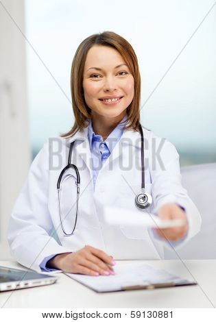 medicine and healthcare concept - smiling doctor with laptop computer