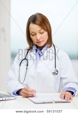 medicine and healthcare concept - busy doctor with laptop computer