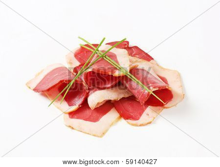 portion of shaved duck breasts decorated with chive