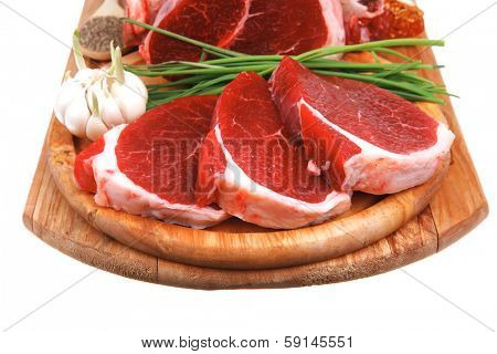 uncooked meat : raw fresh beef pork rib and fillet ready to cooking with garlic and green stuff over wood isolated on white background