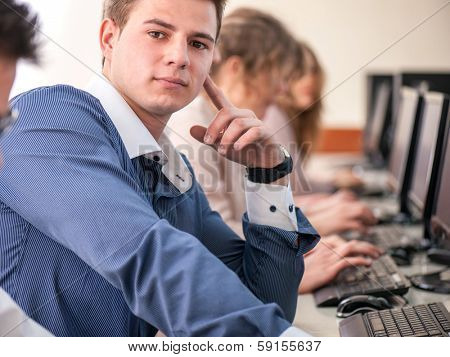 Young college student sitting in schoolroom