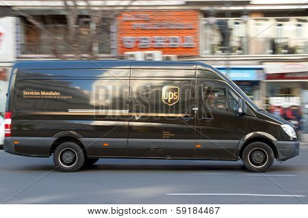 VALENCIA, SPAIN - JANUARY 28, 2014: UPS delivery van on the street in Valencia. UPS is one of largest package delivery companies worldwide with 397,100 employees and USD 54.1 billion revenue (2012).