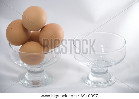 Two bowls one of wich with eggs.