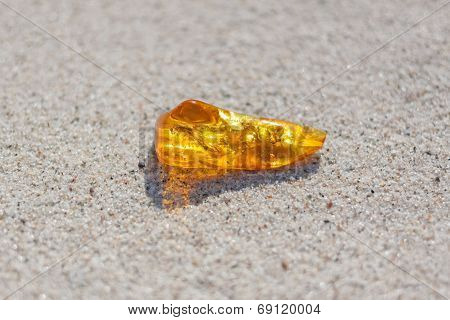 amber with inclusions on sand