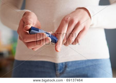 Female Diabetic Checking Blood Sugar Levels