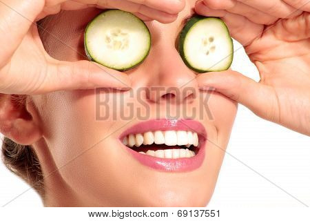 Young Beautiflul Smiling Girl Applying A Cucumber Beauty Treatment