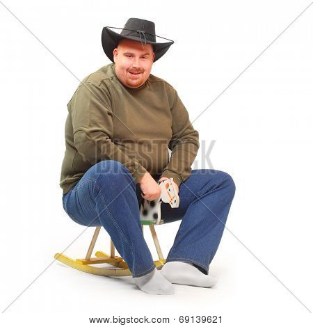 Overweight cowboy riding on a rocking horse.