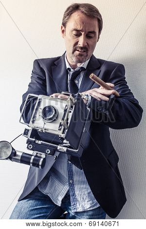 Photographer With Old Camera Looking At His Watch