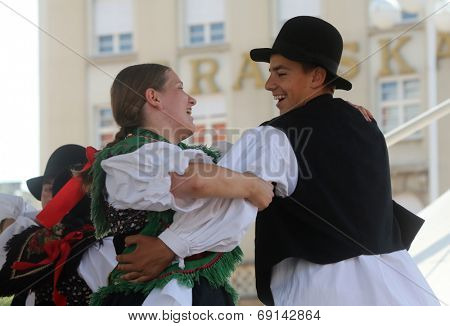 ZAGREB, CROATIA - JULY 19: Members of folk group Seljacka sloga from Donja Dubrava, Croatia during the 48th International Folklore Festival in center of Zagreb, Croatia on July 19, 2014