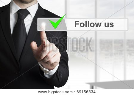 Businessman Pressing Touchscreen Follow Us