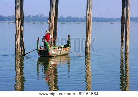 AMARAPURA, MYANMAR - DECEMBER 31: An unidentified man fishes in a lake on December 31, 2011 in Amara