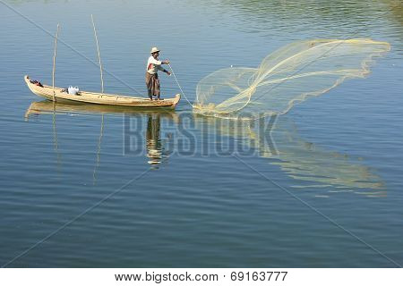 AMARAPURA, MYANMAR - DECEMBER 31: An unidentified man fishes in a lake on December 31, 2011 in Amara