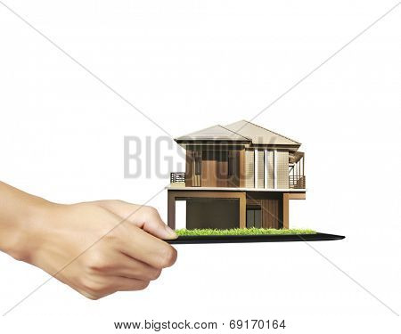 house on ,touch- tablet in a hands 