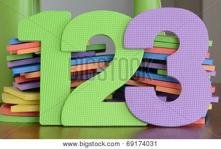 Colorful numbers 1, 2, 3, in a row of flat foam number toys