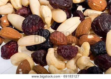 mixed nuts and dried fruits isolated on white background