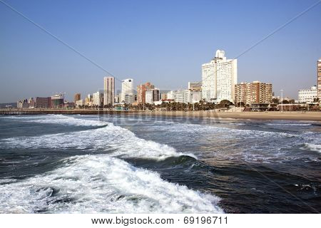 Empty Ocean And Beach Against City Skyline