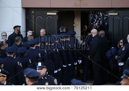 NYPD officers file into church