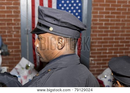 NYPD officer waits to light candle