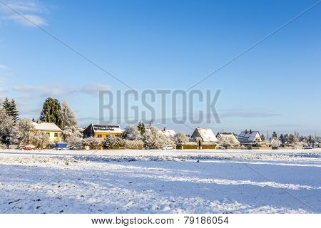 Snow Covered Fields With Settlement At The Horizon In Munich
