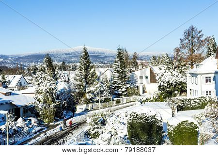 Snow Coverede Houses And Mountains In Schwalbach