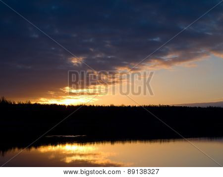 Sun rises over the forest lake
