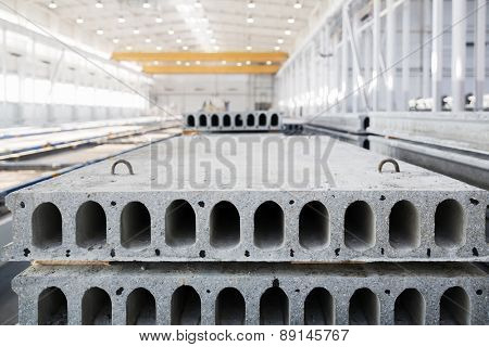 Stack of precast reinforced concrete slabs in a house-building factory workshop