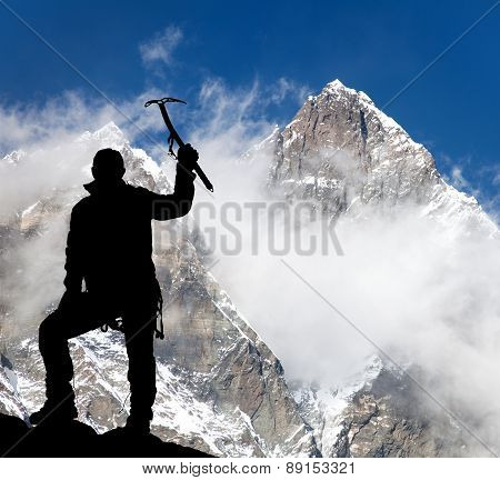 Mount Lhotse And Silhouette Of Man Wirh Ice Axe