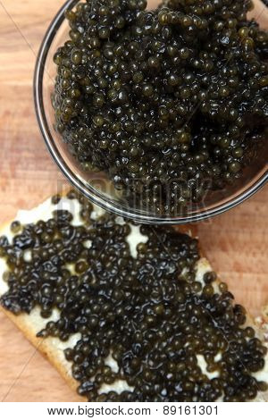 Black and red caviar in glass container